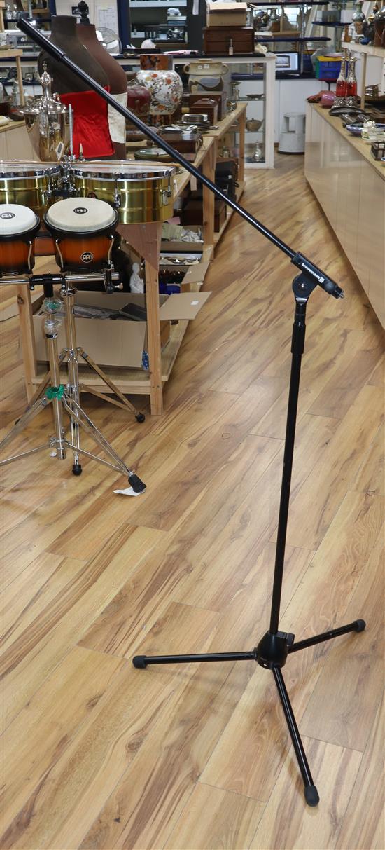 Five assorted microphone stands and a guitar stand